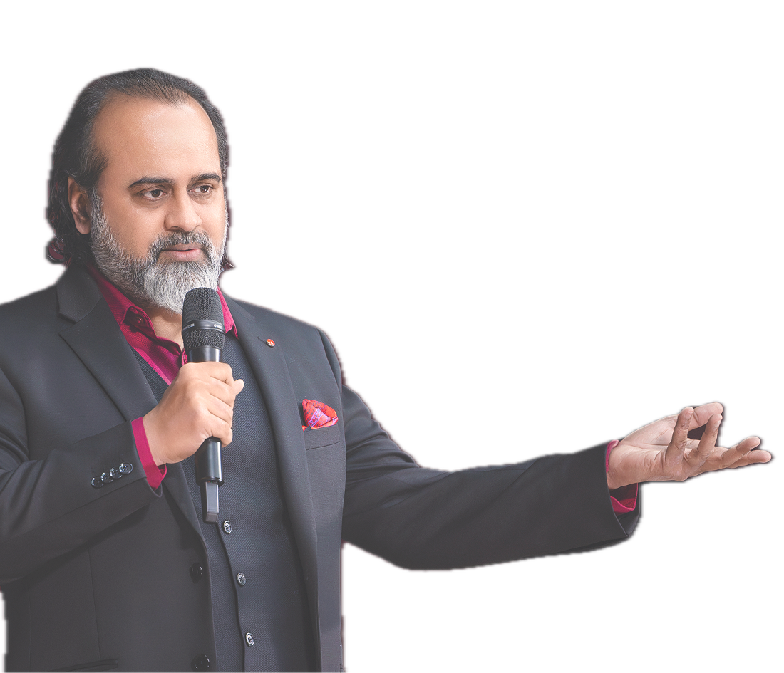 Acharya Prashant speaking into a microphone with his hand extended